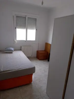a white room with a bed and a window at Dormir sleep Comidad 100 in Barcelona