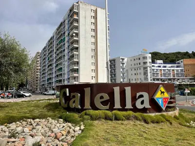 a sign in front of a large building at Flat with birdsongs & character! in Calella