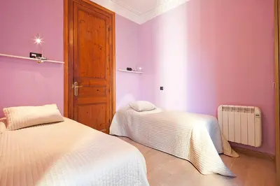 a bedroom with two beds and purple walls at Catalunya Executive 3 bedrooms, 3 bathrooms AC wifi in Barcelona