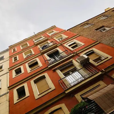a tall red brick building with windows and balconies at Habitación privada junto al mar en la Barceloneta in Barcelona