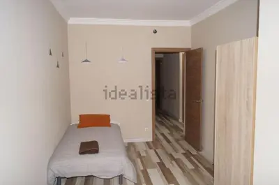 a small room with a bed and a hallway at FELIPE II Apartment in Barcelona