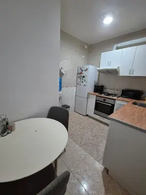 a kitchen with a white table and a white refrigerator at Mary home in Barcelona