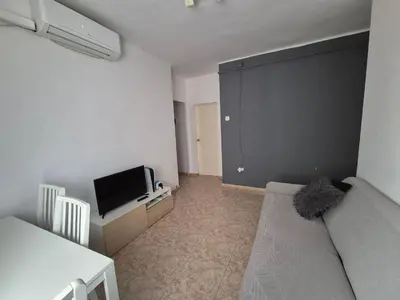 a small living room with a couch and a tv at Mary home in Barcelona