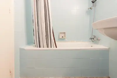 a bathroom with a tub and a shower curtain at Pubone AT Barberà del Valles in Barbera del Valles