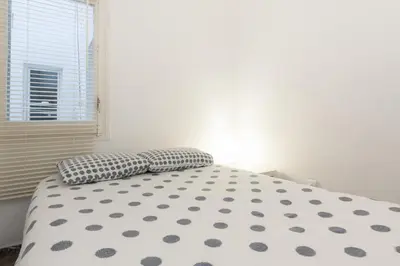 a white bed with two pillows in a bedroom at Pubone AT Barberà del Valles in Barbera del Valles