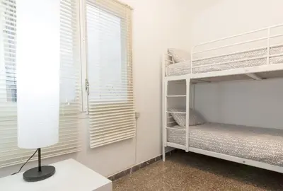 a bedroom with two bunk beds and a window at Pubone AT Barberà del Valles in Barbera del Valles