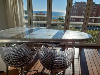 a table and chairs on a balcony with a view of the ocean at Vistas al mar y garaje cerca de BCN in Sant Vicenç de Montalt