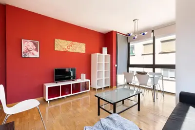 a living room with a red accent wall at Stay U-nique Apartments Bonsoms in Barcelona