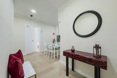 a living room with a table and a mirror at Habitación 1 NOU DE LA RAMBLA in Barcelona