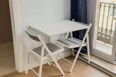 a desk and a chair next to a window at Habitación 1 NOU DE LA RAMBLA in Barcelona