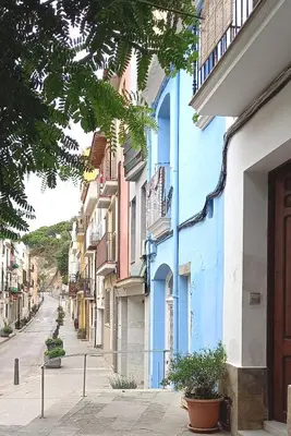 an empty street with blue and white buildings at Oasis cerca de Barcelona in Sant Vicenç de Montalt