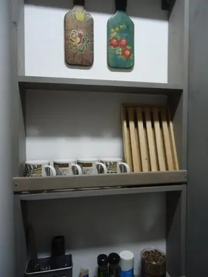 three vases and chopsticks sitting on top of a shelf at Apartment Dolce Vita lovely in Sitges