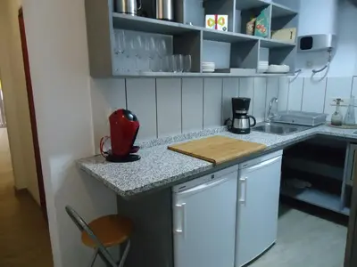 a kitchen with a counter with a red appliance on it at Apartment Dolce Vita lovely in Sitges