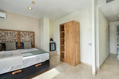 a bedroom with a large bed and a wooden cabinet at Limonaia in Barcelona