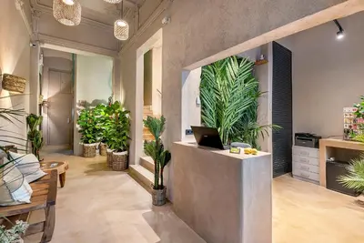 a lobby with a reception desk with potted plants at Limonaia in Barcelona