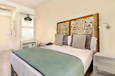 a bedroom with a large bed with a wooden headboard at Limonaia in Barcelona