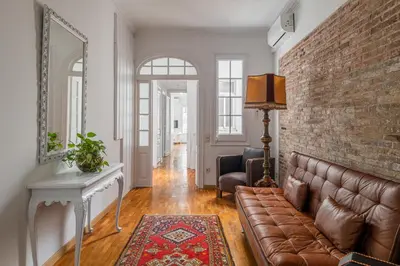 a living room with a couch and a brick wall at Stay U-nique Apartment Creu Coberta II in Barcelona