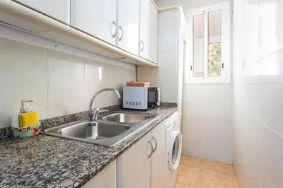 a kitchen with a sink and a microwave at Apartament Clot 2 in Barcelona