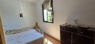 a bedroom with a bed and a dresser and a window at Metrópolis in Barcelona