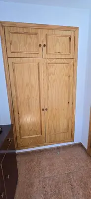 a wooden cabinet in a corner of a room at Metrópolis in Barcelona