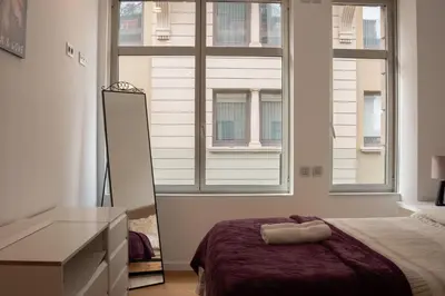 a bedroom with a bed and a large window at Cathedral Charm on Via Lantana in Barcelona