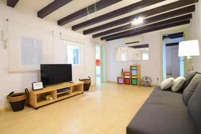 a living room with a couch and a flat screen tv at Apartment in the heart of Barcelona in Barcelona