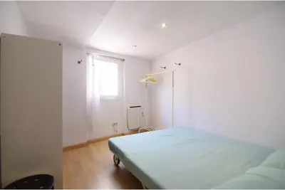 a white room with a bed and a window at Apartment in the heart of Barcelona in Barcelona