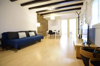 a living room with a blue couch and a table at Apartment in the heart of Barcelona in Barcelona