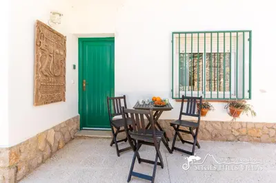 a patio with tables and chairs and a wooden canopy at Casa Sian Retreat near Sitges in Olivella