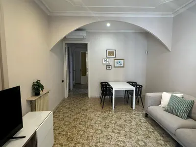 a living room with a couch and a table at Gran Via Green in Barcelona
