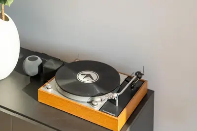 a record player with a vinyl record on a table at Infinity House in Cabrera de Mar