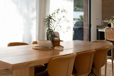 a dining room table with chairs and a wooden table at Infinity House in Cabrera de Mar
