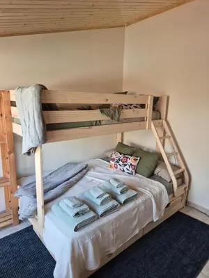 a bunk bed with pillows on it in a room at Gran terrassa al cantó del mar in Canet de Mar