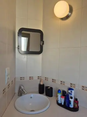 a bathroom with a sink and a mirror at Gran terrassa al cantó del mar in Canet de Mar