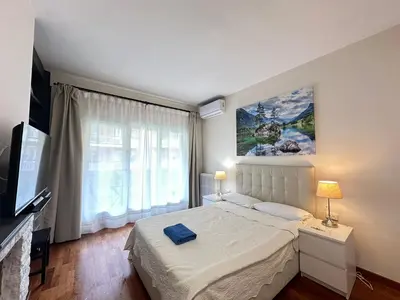 a bedroom with a bed and a large window at Apartamento en Viladomat in Barcelona