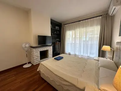 a bedroom with a bed and a fireplace at Apartamento en Viladomat in Barcelona