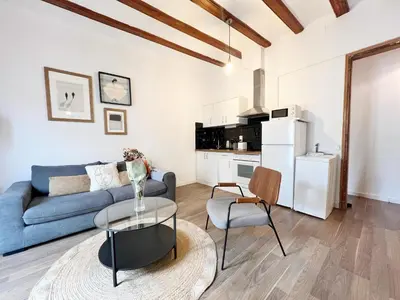 a living room with a blue couch and a table at Roser Apartment in Barcelona