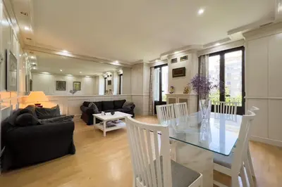 a dining room and living room with a glass table at Gran Vía Sun in Barcelona