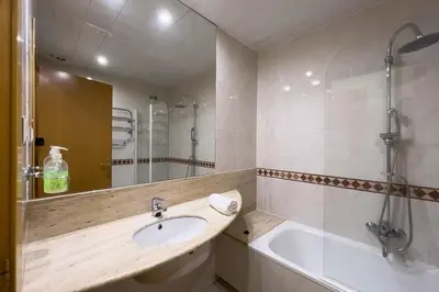 a bathroom with a sink and a bath tub at Gran Vía Sun in Barcelona