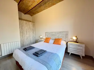 a bedroom with a bed with orange pillows on it at Pamplona Playa Apartment in Barcelona
