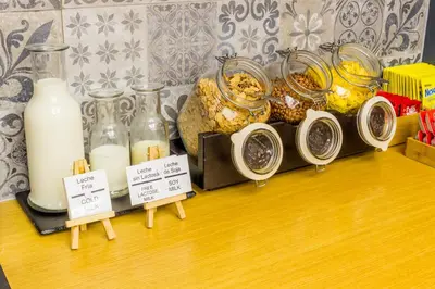 a display of milk and other items on a table at Boutique Hostemplo Sagrada Familia in Barcelona