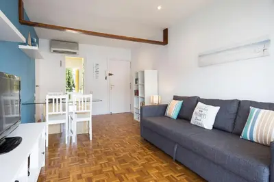 a living room with a couch and a kitchen at Stay U-nique Apartments Sitges Beach in Sitges
