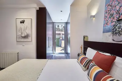 a bedroom with a large bed and a large window at BBarcelona Brusi Flat in Barcelona