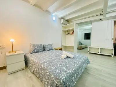 a large bedroom with a bed and a night stand at 11 Principal Barca in Barcelona