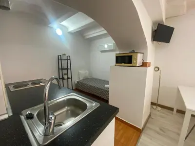 a kitchen with a sink and a microwave in a room at 11 Principal Barca in Barcelona