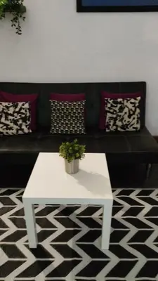 a white coffee table in a living room with a couch at Loft Center Rambla in Barcelona
