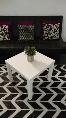 a white coffee table in a living room with a couch at Loft Center Rambla in Barcelona