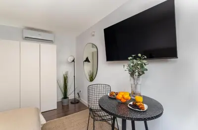 a living room with a table with oranges on it at Sunshine Studios Portside Gothic in Barcelona