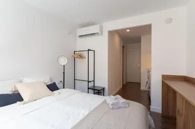 a bedroom with a large white bed in a room at Sunshine Studios Portside Gothic in Barcelona
