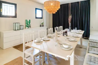 a kitchen with black cabinets and a counter top at Villa Caliza in Cunit with Private Pool and large garden - air conditioning in bedroom in Cunit